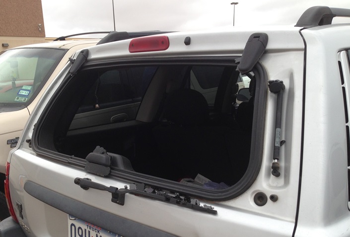 Rear car window smashed by hail.